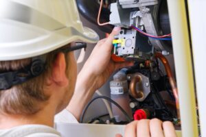 technician repairing gas furnace