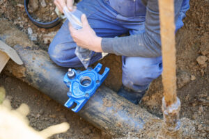 construction worker, repairing a broken water pipe
